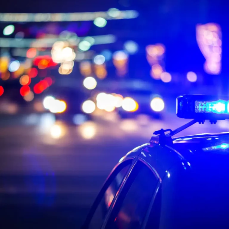 night police car lights in city - close-up with selective focus and bokeh background blur
